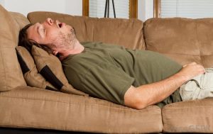 man sleeping on couch